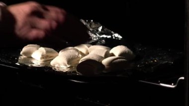 Putting party food selection in the oven close up slow motion 4k shot selective focus