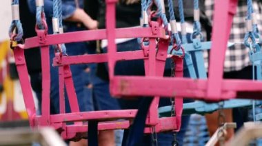 Fairground chair swing ride at fun fair medium 4k shot slow motion selective focus