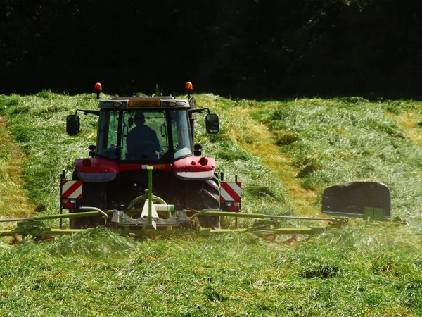 stock image Summer meadow with tractor in distance medium shot selective focus