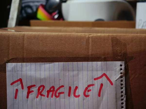 Moving home with fragile kitchen items in a box close up shot selective focus