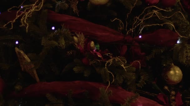 きらめくライトで飾られた伝統的なクリスマスツリーを閉じる4Kショット選択的フォーカス — ストック動画
