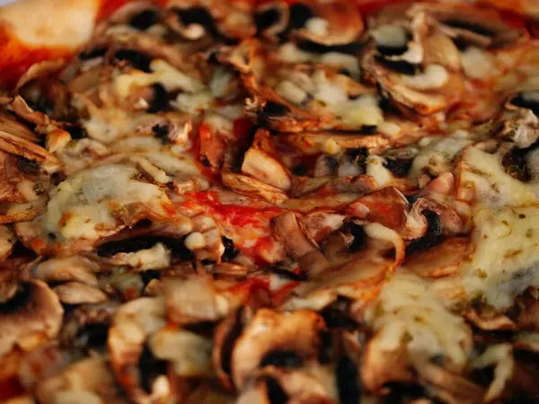 Cheese and mushroom pizza close up shot selective focus