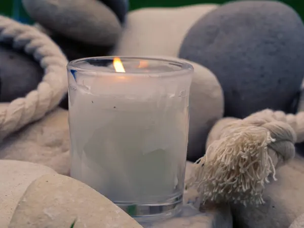 Relaxing Zen candle and stones meditation display close up selective focus