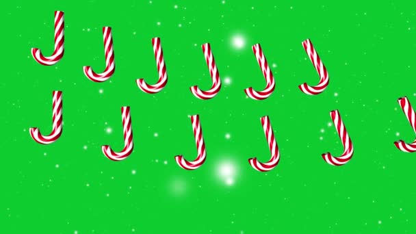 緑のクリスマスの雪の背景に落ちるキャンディー ケイン 4Kアニメーション — ストック動画