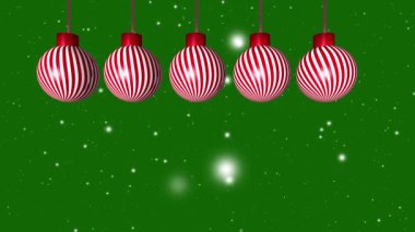 Yeşil Noel süslemeleri yeşil arka planda, kar taneleri 4k animasyon yapıyor.