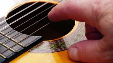 Akustik gitar çalan müzisyen yakın çekim yavaş çekim 4k seçici odak