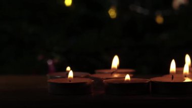 Tealight candles flickering with bokeh background close up dolly zoom shot selective focus