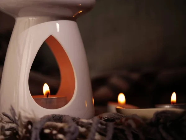 Essential oil burner with candles medium shot selective focus