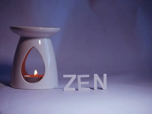 Zen Essential oil burner on blue background medium shot selective focus