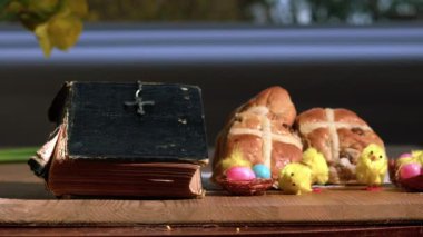 Paskalya 'yı kutlamak için İncil ve sıcak çörekler 4k ağır çekim seçici odak noktası