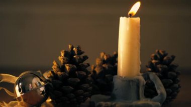 Noel ışıklarının önünde çam kozalaklı mum yakın çekim seçici odak noktası