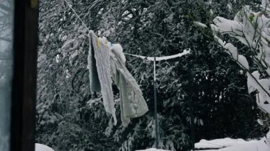Kapılar çamaşır ipiyle kapanır. Bahçedeki çamaşır ipiyle kaplıdır. Karla kaplıdır.