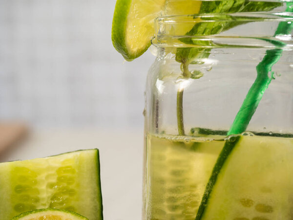 Healthy cucumber mint and lime refreshing detox drink close up shot selective shot