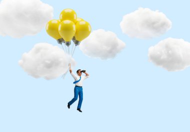 Fikirlerle Yükselen: İşadamı Ampul Balonlarıyla Yüzüyor