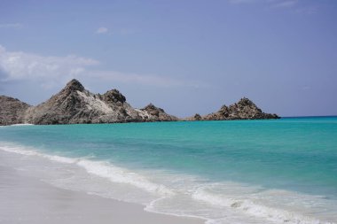 Beautiful tropical desert island: blue sea, rocky beach, transparent sea water - Socotra Island, Yemen clipart