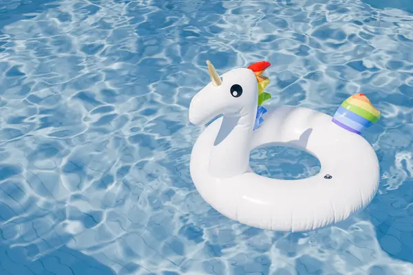 3D rendering of an inflatable unicorn float in a swimming pool with clear water, summer concept.