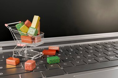 Noel hediyeleriyle dolu alışveriş arabası dizüstü bilgisayarda duruyor ve tatillerde online alışverişi temsil ediyor. 3d oluşturma