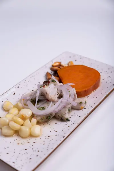 stock image Food very demanded in the region of Peru called Ceviche and presented on a white background.