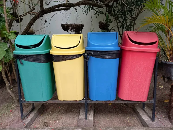 several plastic bins with different colors for garbage collection and separation