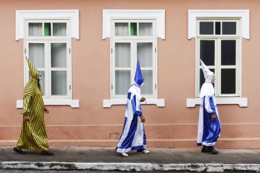 Minas Gerais, Brazil - March 4, 2019: masked people known as cainaguas wearing their characteristic colorful clothes on the streets during carnival in the interior of Minas Gerais