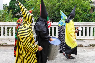 Minas Gerais, Brazil - March 4, 2019: masked people known as cainaguas wearing their characteristic colorful clothes on the streets during carnival in the interior of Minas Gerais