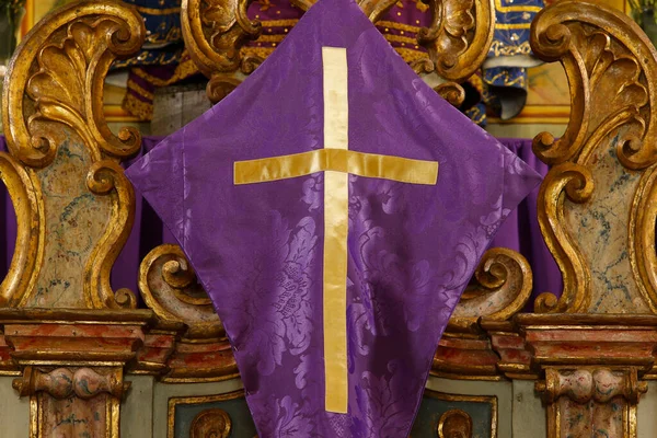Lent and Holy Week - sacred image covered with purple fabric and symbol of the cross - religious concept