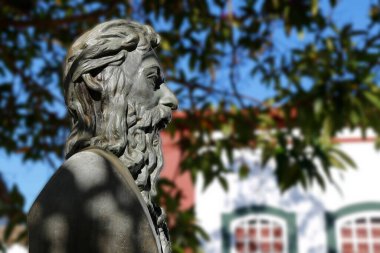 Tiradentes, Minas Gerais, Brazil - July 14, 2021: Tiradentes metal statue representing the ensign on a public road - side view clipart