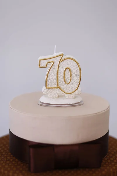 detail of the number seventy on the top of the birthday cake, 70 birthday, white cake, 70 year old birthday cake candle