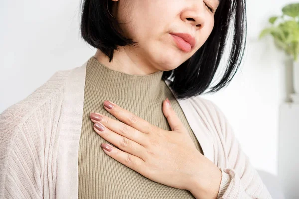 stock image Close-Up of Asian Woman Experiencing Shortness of Breath and Panic Attack, Clutching Her Chest