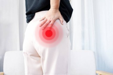 Piriformis syndrome concept with woman suffering from buttock muscle pain when sitting clipart