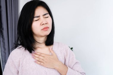 Asian woman having heart attack, chest pain, difficulty to breathe clipart