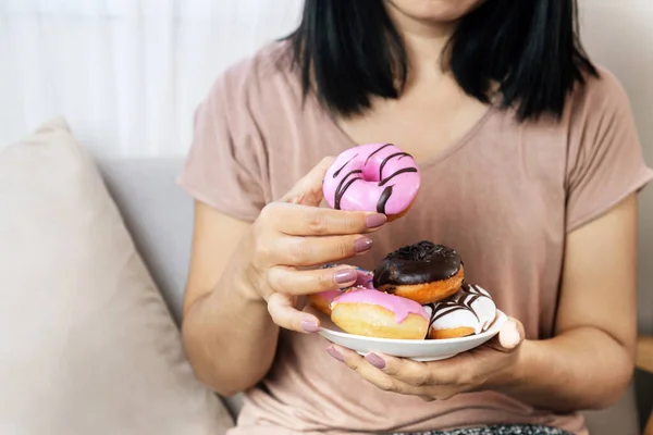 妇女手吃甜甜圈 糖瘾观念 不健康的吃甜食 — 图库照片