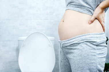 woman with big abdomen in the toilet have problems with chronic constipation, lazy bowel syndrome, and  Digestive system concept clipart