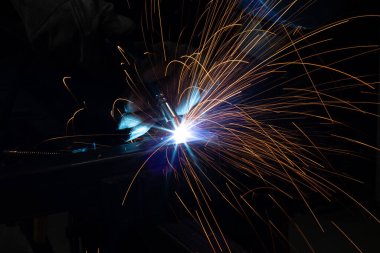 Kaynakçı, mig veya tig kaynakçı, zanaatkar, teknik çelik sanayi, kaynak tabancasından güzel kıvılcımlar, fabrikadaki çelik kaynakçı