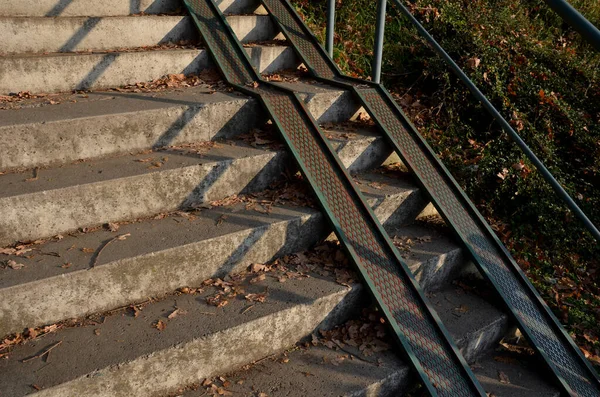 スロープとグレーのコンクリートの階段と車椅子専用の手すりが組み合わされています 都市公園に入るためのセキュリティの趣のある解決策 板金レール — ストック写真