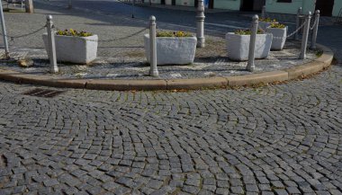 Köy merkezindeki süslü saksılara, menekşeler ve nergislerle süslenmiş beton saksılara. Paskalya yaklaşıyor. Bu yüzden evin girişini süslemek ve park etmek gerekiyor.