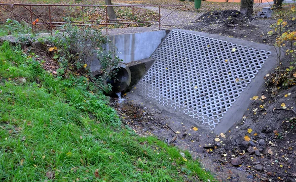 a stream that cobbled into a narrow channel. the upper side is made of concrete grates to reduce meadndring and under-grinding by the water stream. anti-erosion measures of direct melioration flow