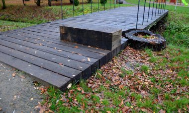 Bir derenin üzerindeki kiriş köprüsü ya da drenaj kanalı. Güçlü kirişler ve ince çelik korkuluklar dizayn edin. Bir ağacı seçmek doğaya saygı duyar. Mobilyalar tüm konsepte uyuyor.