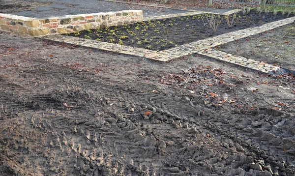 Stock image stone pavement just laid dry in the gravel backfill between two sheet steel curbs. sandstone and pieces of burnt brick with a rustic feel. narrow park paths in the herb garden, low, retaining, burnt