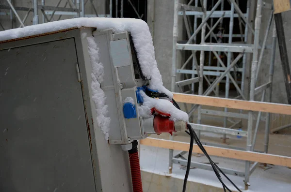watch out for wet and snowy cables. electrical fuses protect workers on the construction site from injury. interrupts the power supply in time with a current phase protector