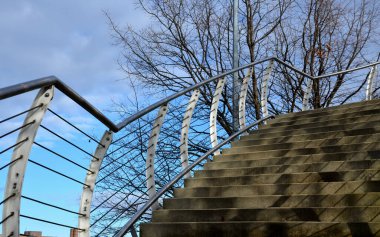 wire mesh fencing with a stainless steel guide wire and a tensioning mechanism with a threaded structural solution. detailed solution for tensioning cable of the railing fence, white, parking