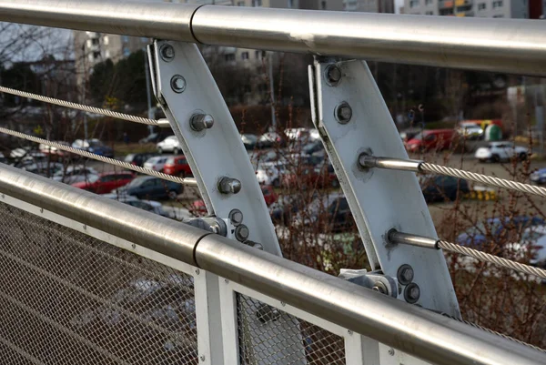 wire mesh fencing with a stainless steel guide wire and a tensioning mechanism with a threaded structural solution. detailed solution for tensioning cable of the railing fence, white, parking