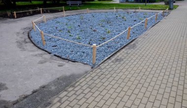 flower bed, treeline, lattice, with a circular hole for a tree trunk that is in middle of a cobbled square, or on a loft. with trunk, ornamental park, paving, arch, square, barrier, dog, landscaping