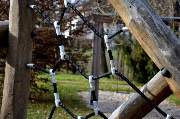rope hemp net connected in a wooden frame by means of metal stainless steel connectors. it is an attraction for children on the playground. sand, screw, terrace, clambering, net, mesh , log, stacked