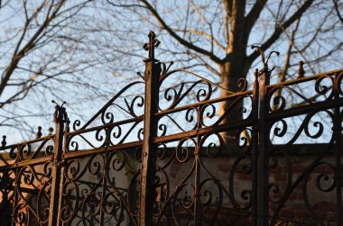 renovation of damaged, broken and stolen tombstones. pre-war runic letters with the names of the dead. rusty and green oxidized grids and lanterns, the collectors of precious metals cut and sold