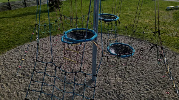 rope hemp net connected in a wooden frame by means of metal stainless steel connectors. it is an attraction for children on the playground. sand, screw, terrace, clambering, net, mesh , log, above