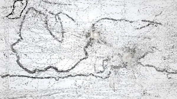 aerial view of footprints of people building snowmen. traces of pushing of large snowballs and thousands of footprints on snow plain. ants from above make similar corridors and paths directions