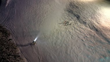 observation of skiers' behavior on the downhill track from a height. artificial snowmaking from water cannons. shoot a stream of water onto furrowed surface. expensive energy intensive technology