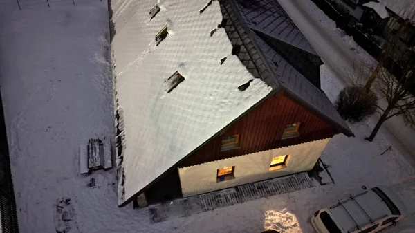 checking the roof with the help of a drone. chimneys and skylights in winter when there is snow it is not safe to climb the ladder. snow drifts can damage roof tiles, mountain building hut, bench,