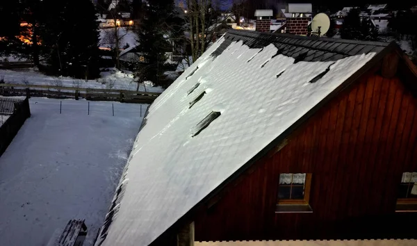 checking the roof with the help of a drone. chimneys and skylights in winter when there is snow it is not safe to climb the ladder. snow drifts can damage roof tiles, mountain building hut, bench,